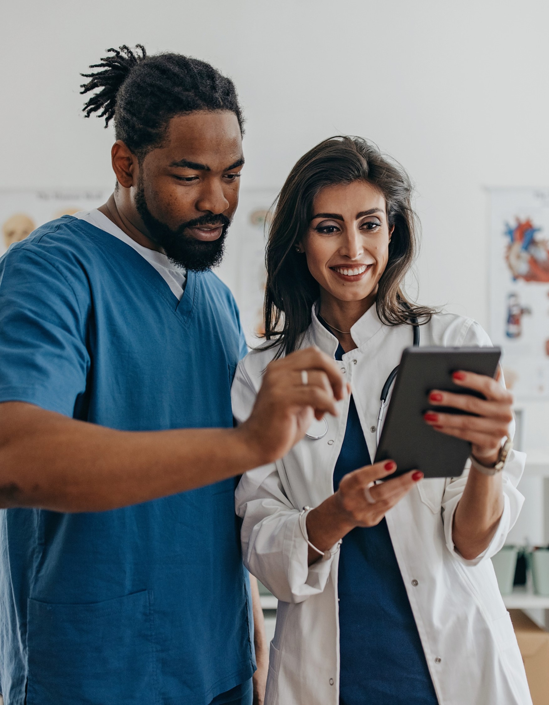Doctor holding iPad with male patient