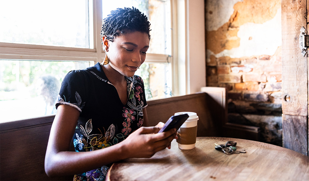 Woman on her phone at a relaxing coffee shop