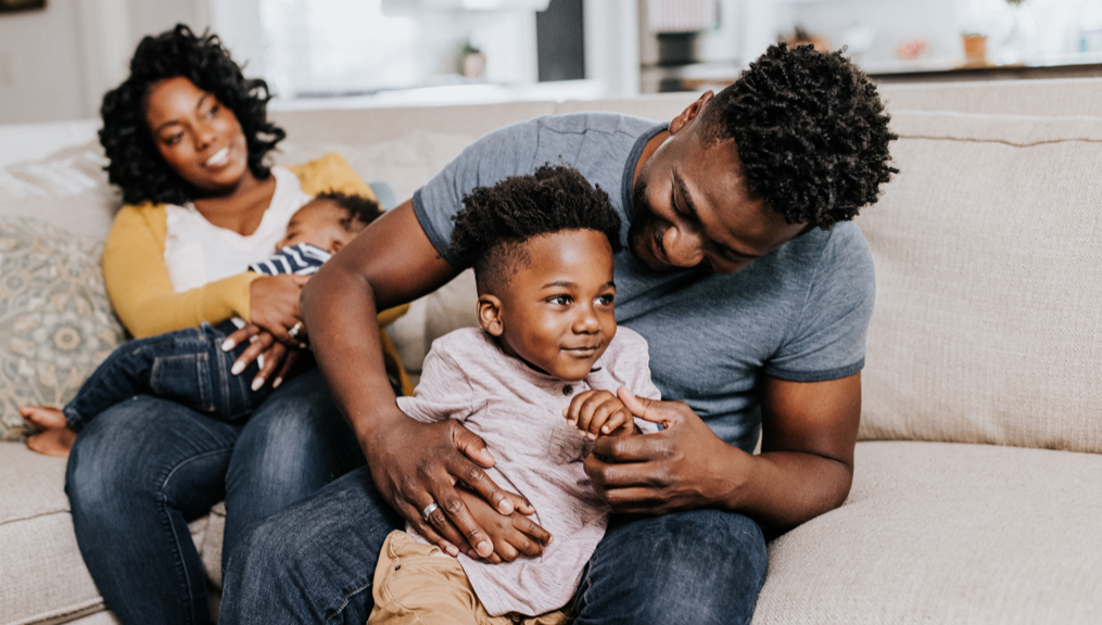 Parents with young son and baby in living room