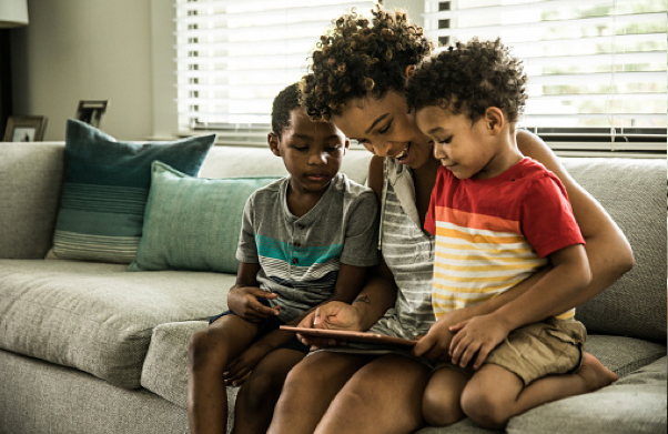 Family syncing health data on tablet