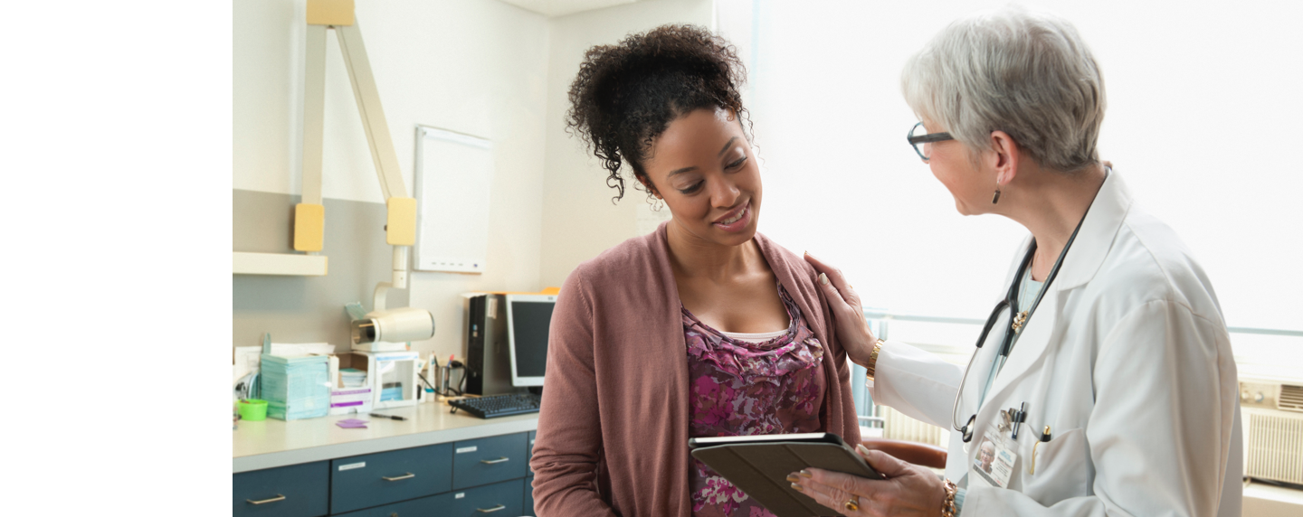 Pregnant woman talking with her doctor