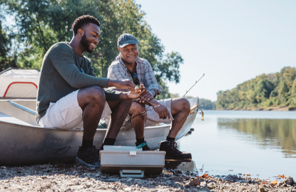 Adult son and father out fishing together