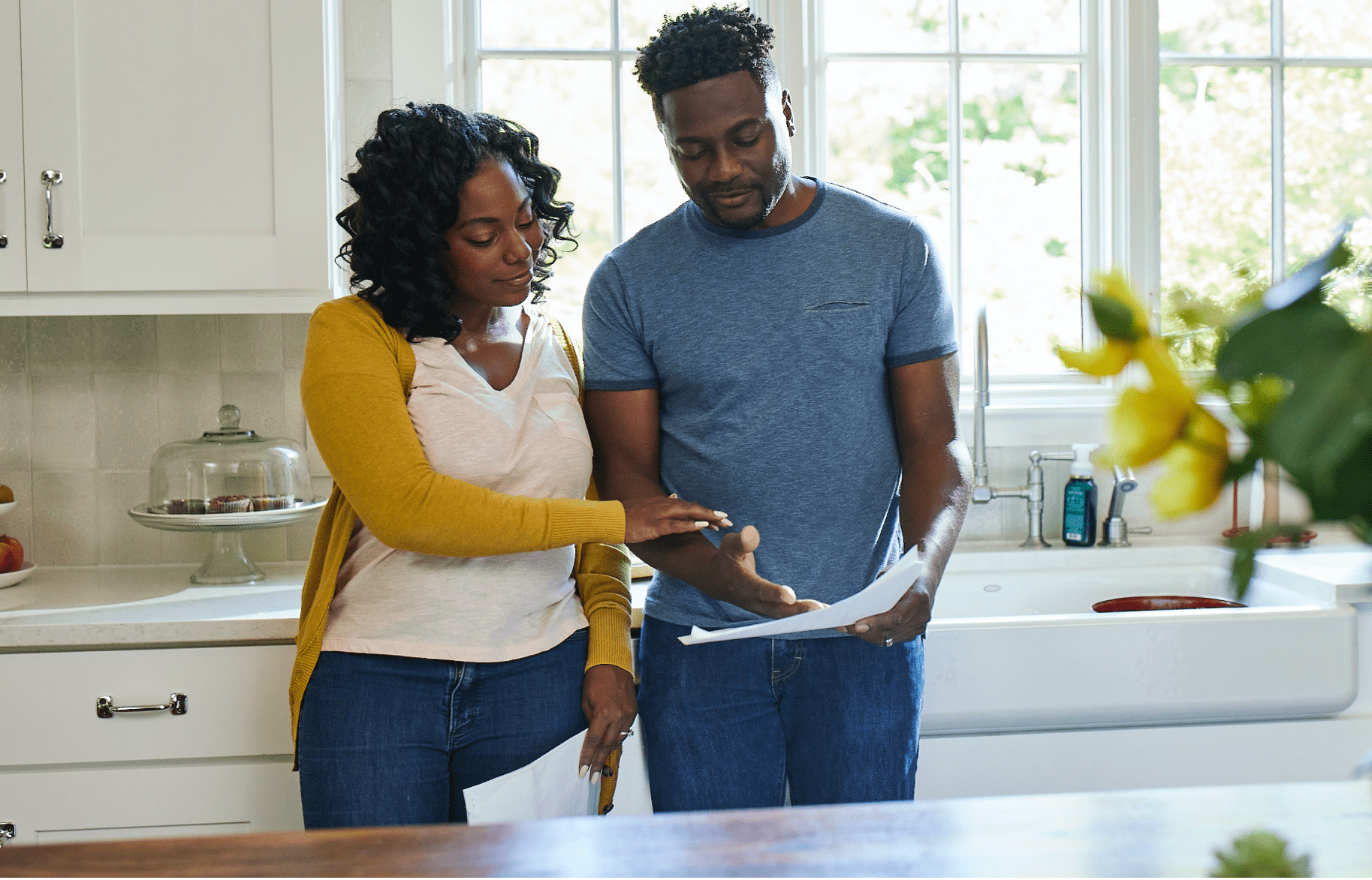 Couple in kitchen looking at paperwork