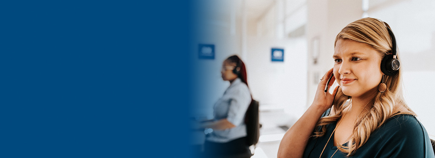 Woman working and talking through a headset.