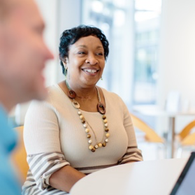 A lady employee at a table during a meeting