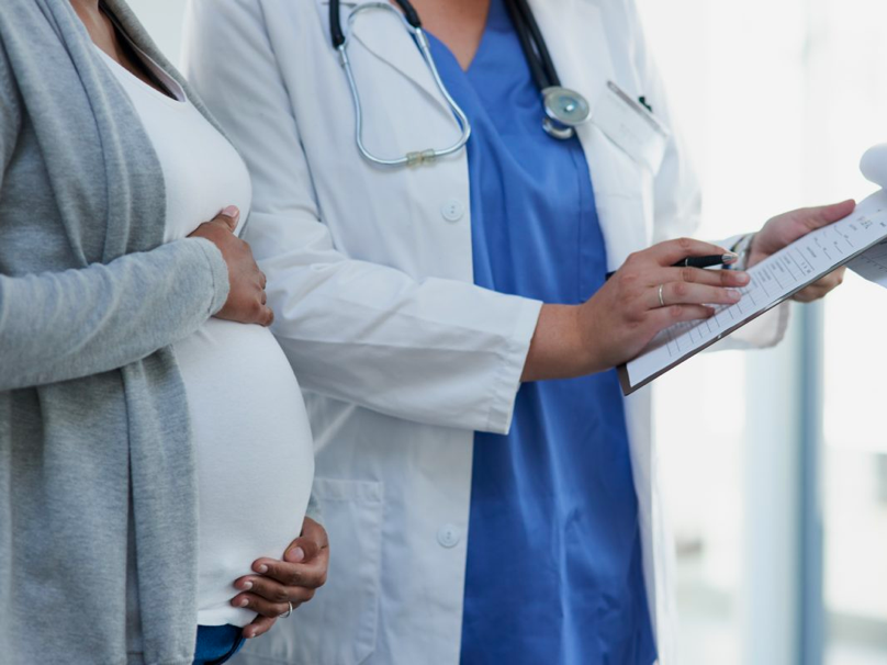 Pregnant woman talking with her doctor