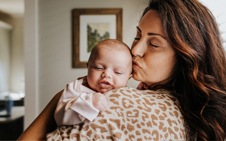  New mother holding her newborn baby.
