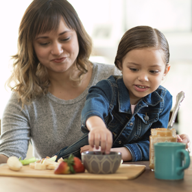 Mother and daughter making healthy snacks