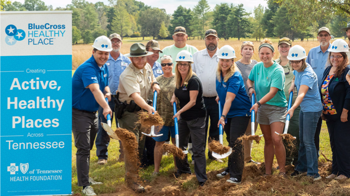  A group of people from blueCross employees to community members, breaking ground for a Healthy Place park.