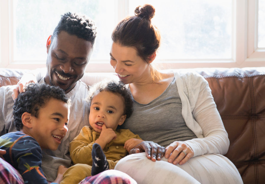 Woman and man holding children and talking | BCBS of Tennessee