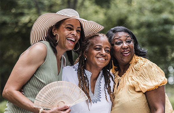 Grandmother and two daughters posing for a photo.