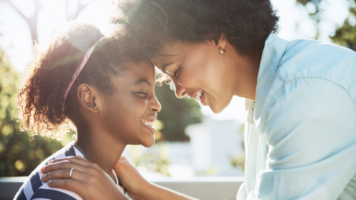 Shot of a cheerful young mother and her daughter putting their heads together while keeping their eyes closed