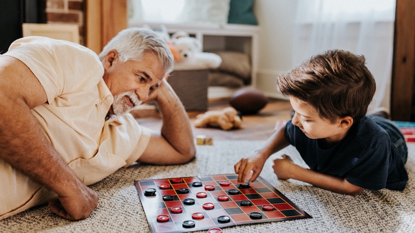 grandfather and grandson playing checkers