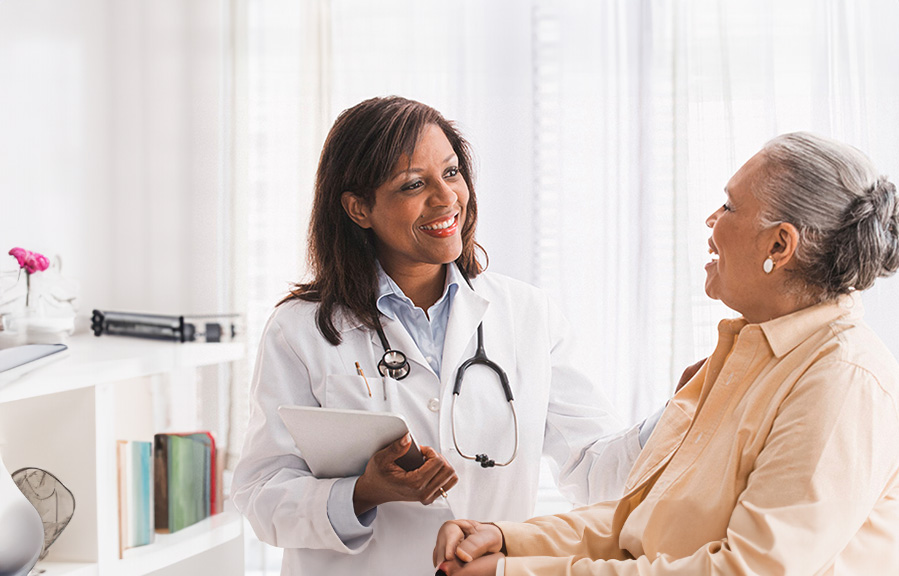 A doctor encourages her senior patient. A doctor encourages her senior patient.