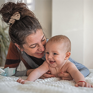 Older mother with happy newborn