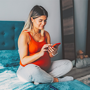 Pregnant woman looking at her phone