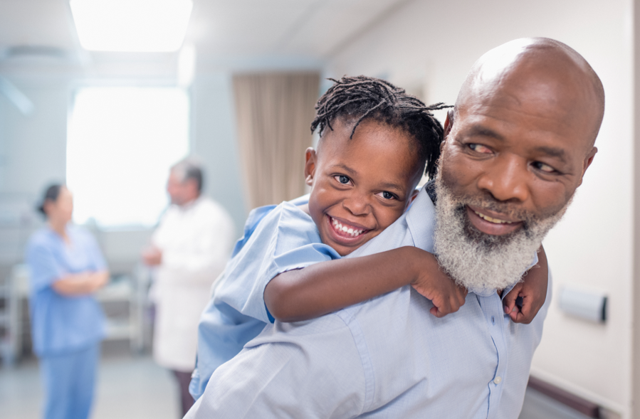 Young child hanging onto dad's back | BCBS of Tennessee