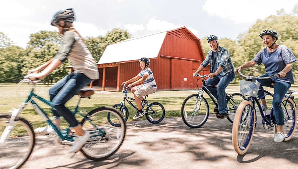 Grandparents and their grandchildren on a bike ride.