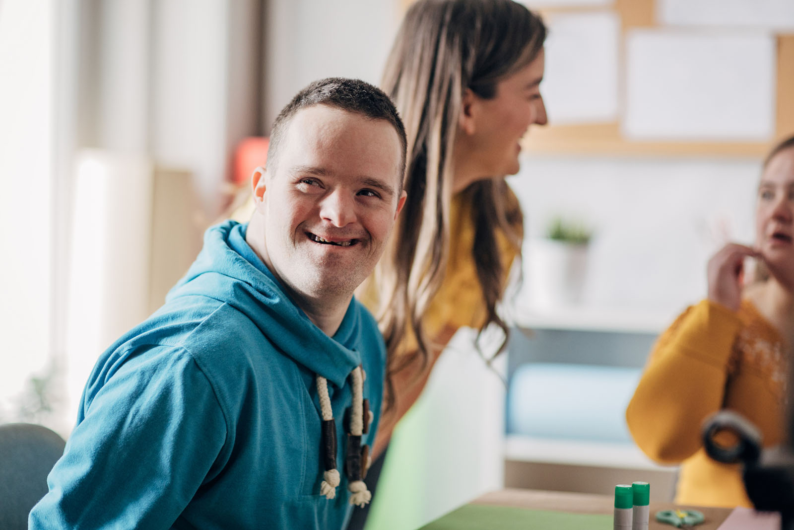Young disabled man similing at someone in the distance